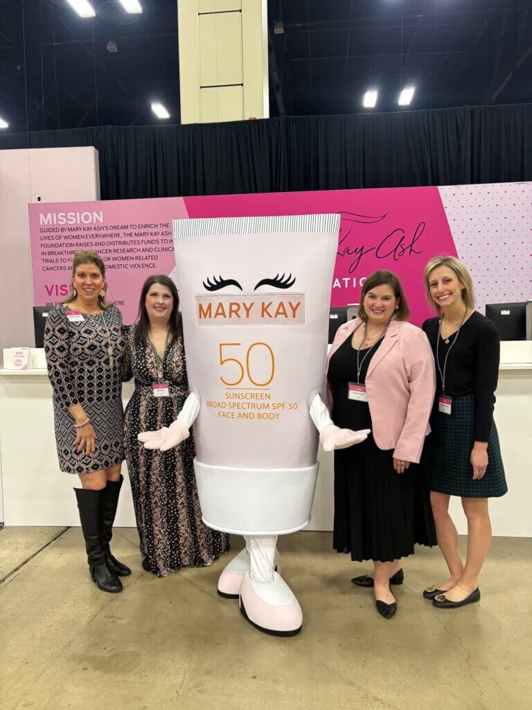 Julia Santosuosso and team members at Mary Kay event